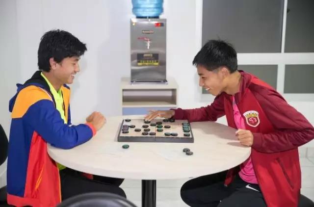 球员薛志承弘（右）与茆瑞在活动室下象棋。
